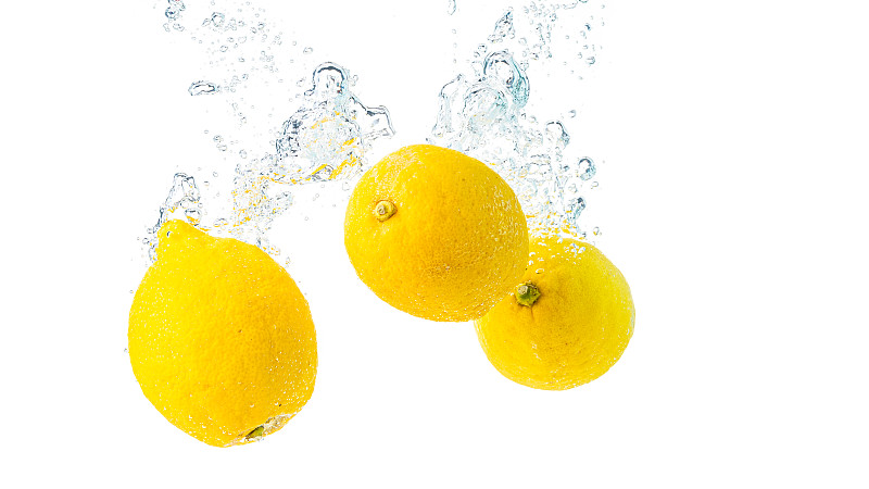 柠檬溅入水的特写白底图片素材