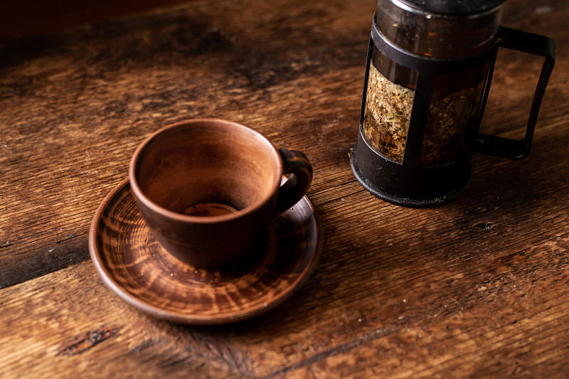 空陶土茶杯。深色木制背景。花草茶茶壶。健康的花草茶。图片下载