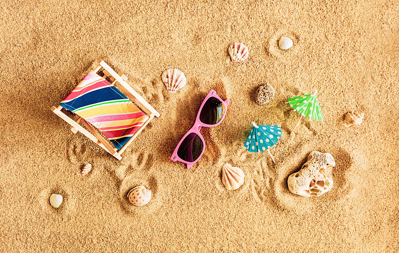 夏日海滩度假海报。金色的沙滩上，木制的躺椅和粉色的太阳镜。图片下载
