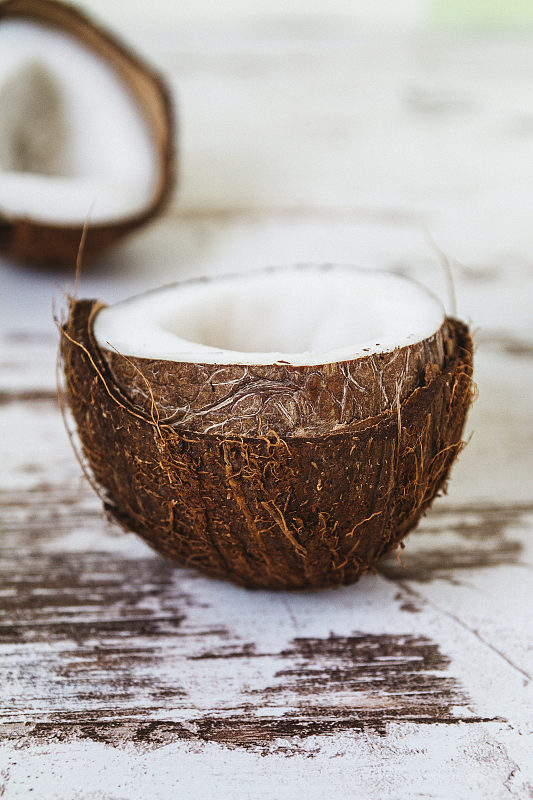 新鲜的生椰子放在质朴的木制桌子上摄影图片