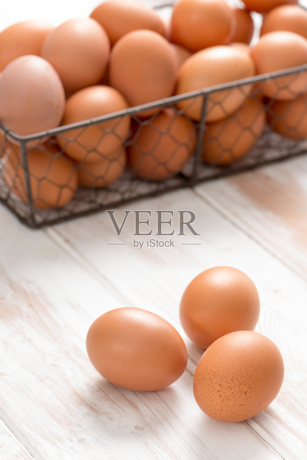 三个棕色的鸡蛋和网格托盘鸡蛋的背景照片摄影图片