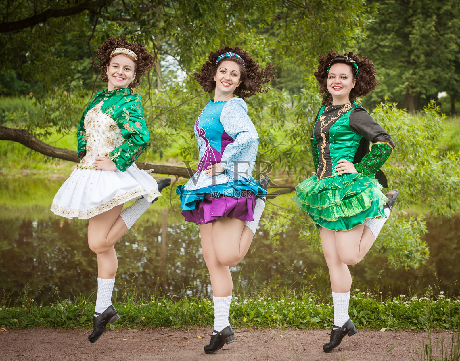 三个年轻漂亮的女孩穿着爱尔兰舞裙跳舞照片摄影图片