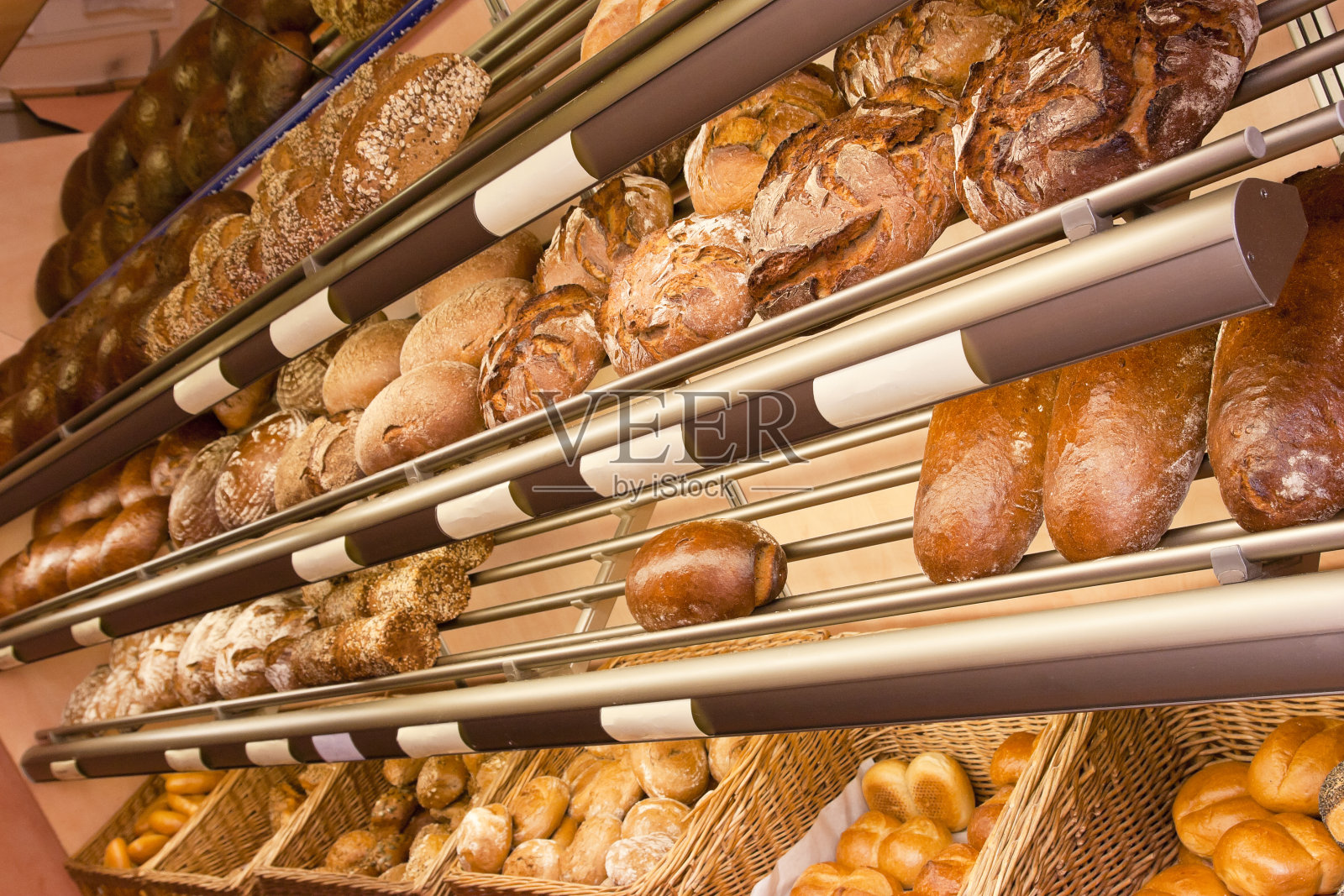 面包店的架子上放着面包和小圆面包照片摄影图片