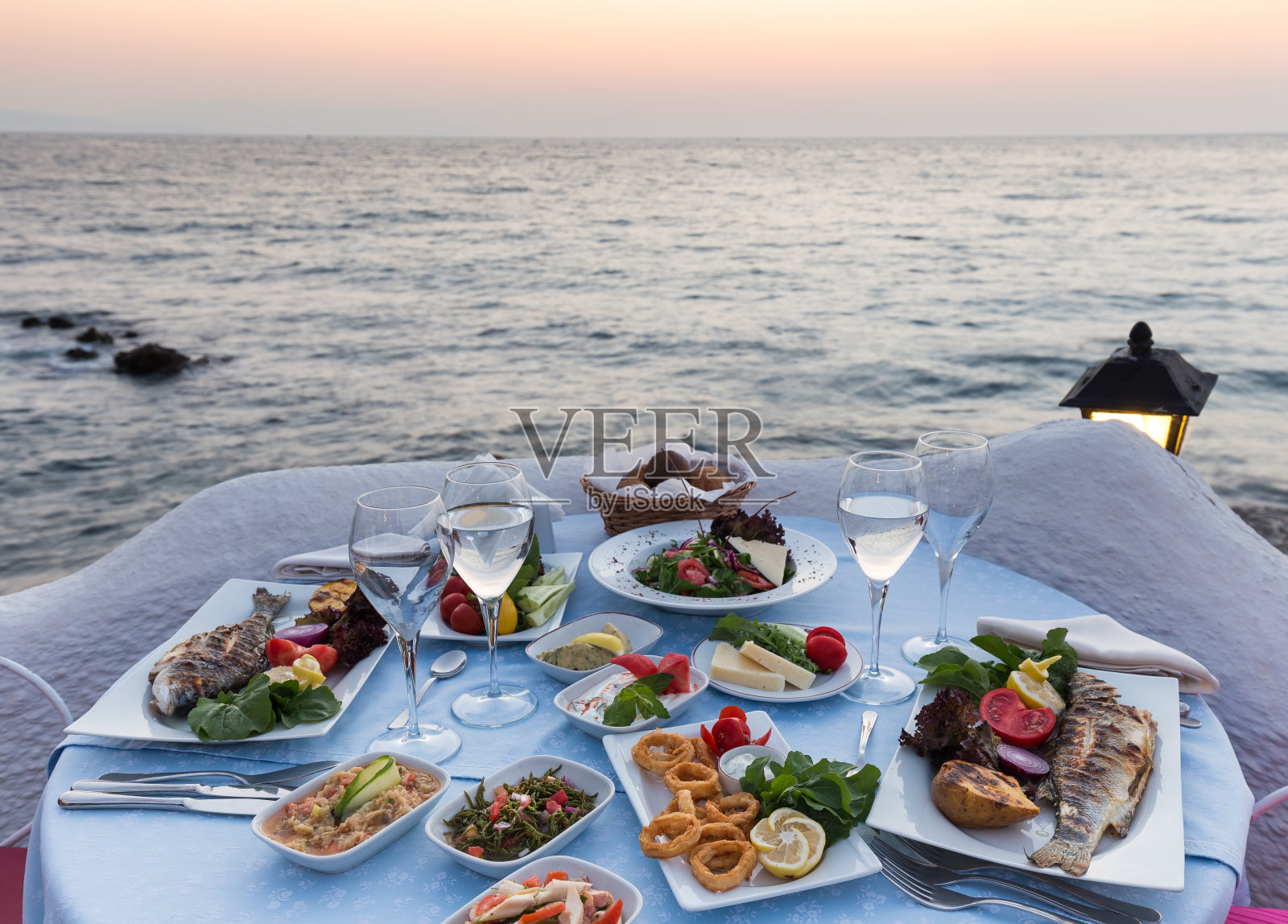 漂亮的餐桌为夫妇准备在日落与和平的海景照片摄影图片