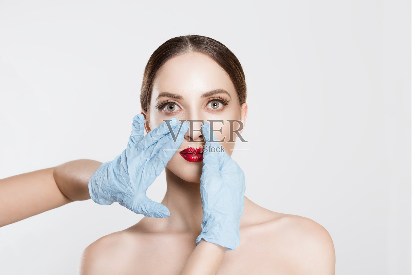 鼻整形术。想要美丽就需要美丽。特写肖像医生用手套触摸女人的脸鼻子想改变她的形式做整形手术。裁剪图像水平工作室拍摄照片摄影图片