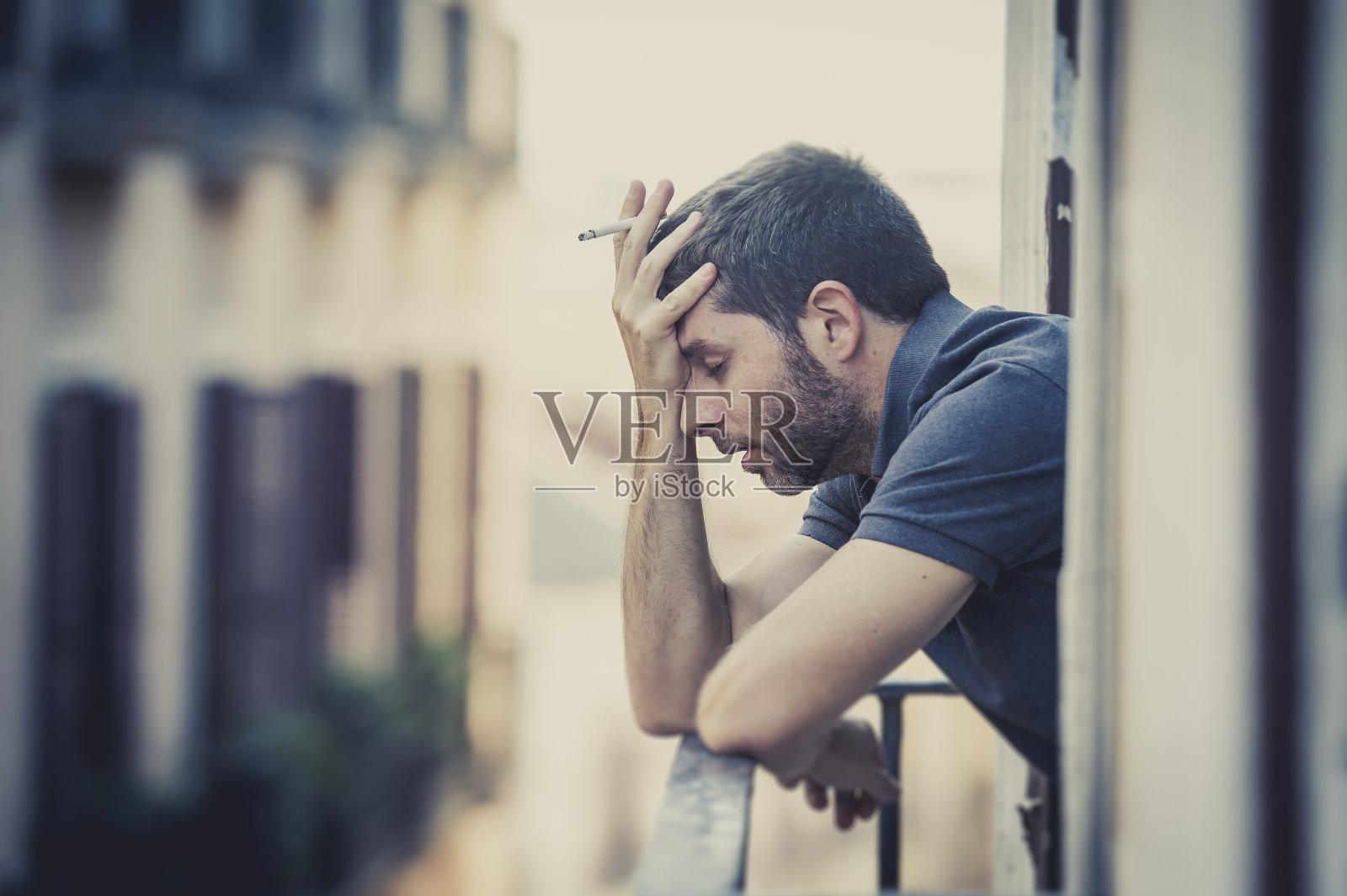 阳台上的一名年轻人在抑郁症中遭受情感危机照片摄影图片