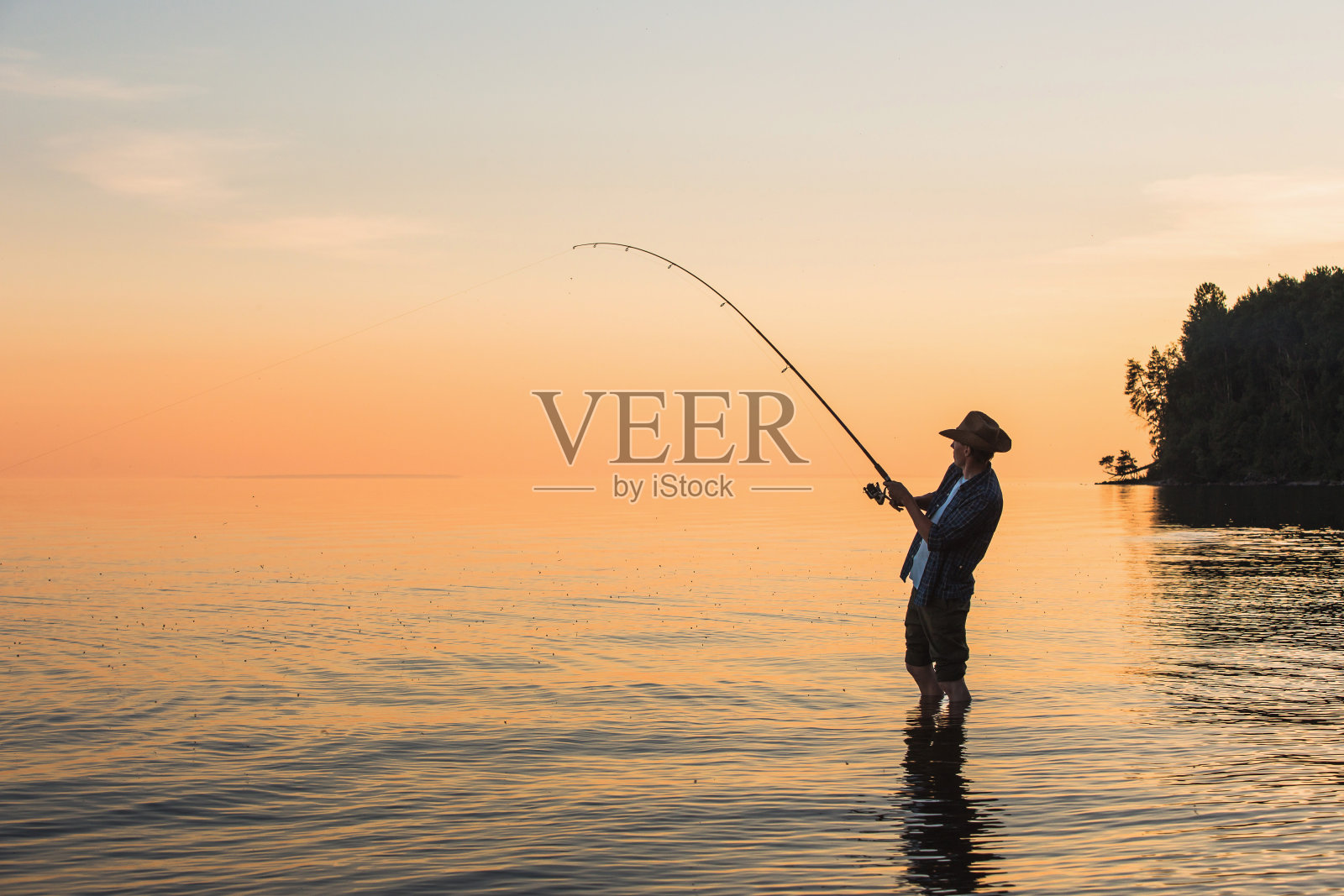 日落时分，湖边的渔夫照片摄影图片