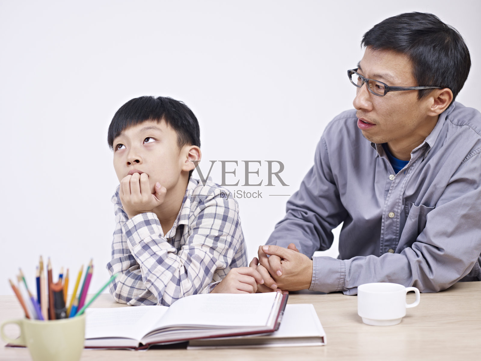亚裔父亲和儿子正在进行严肃的谈话照片摄影图片