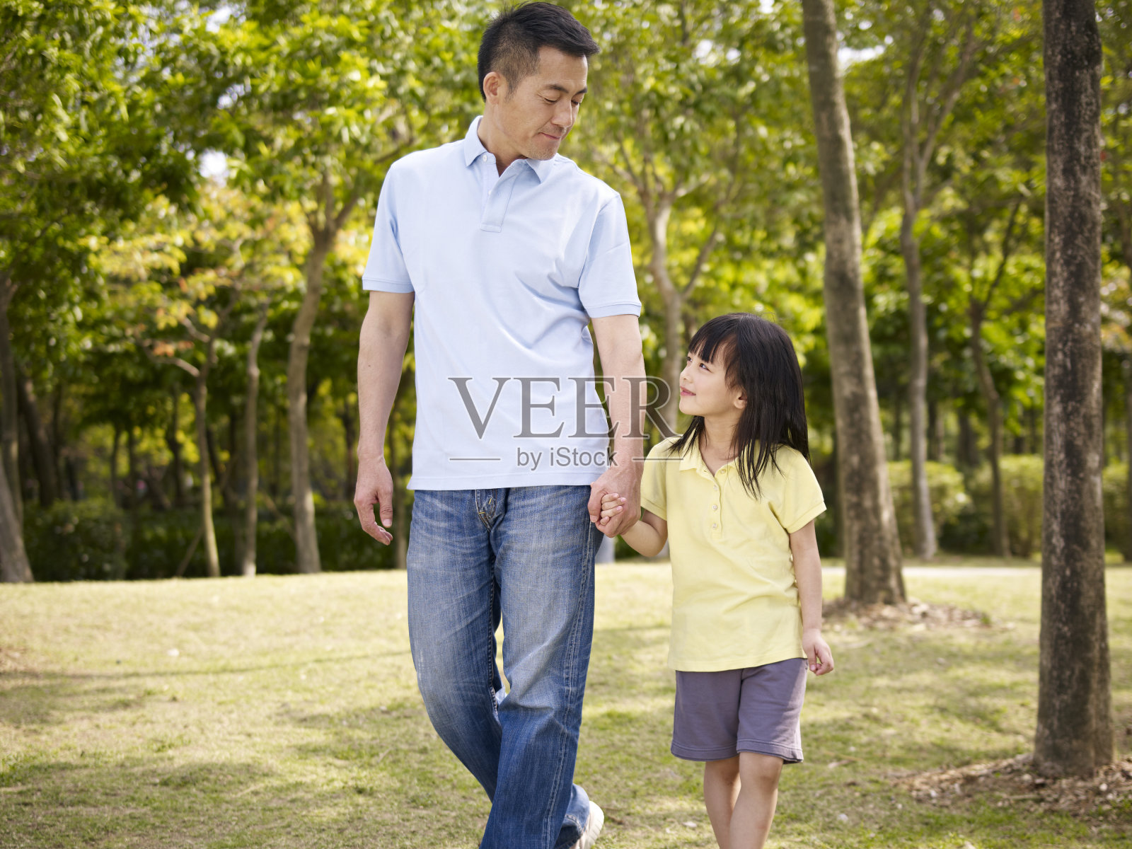 亚裔父亲和女儿在公园散步照片摄影图片