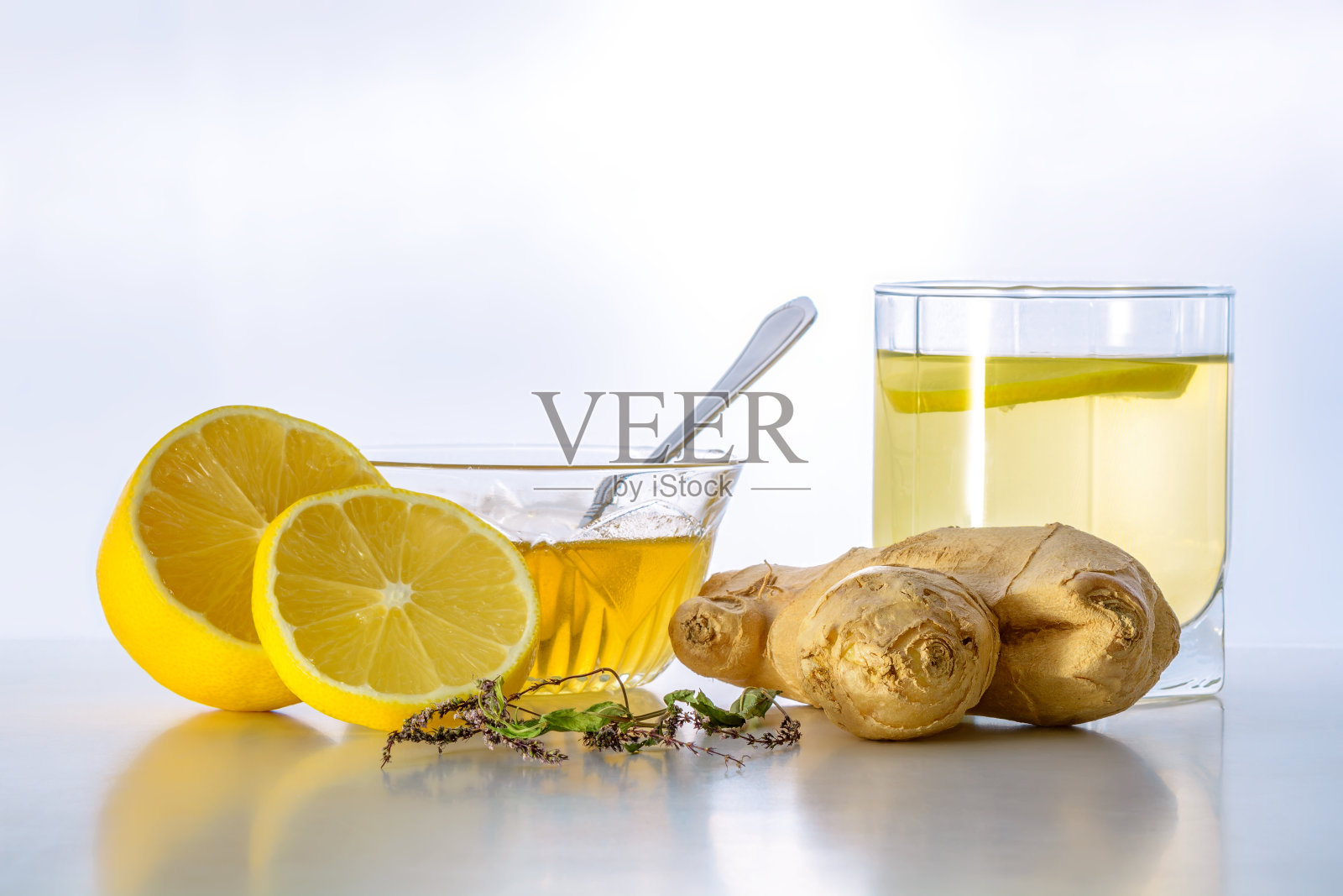 一杯姜茶，蜂蜜和柠檬在白色的背景照片摄影图片