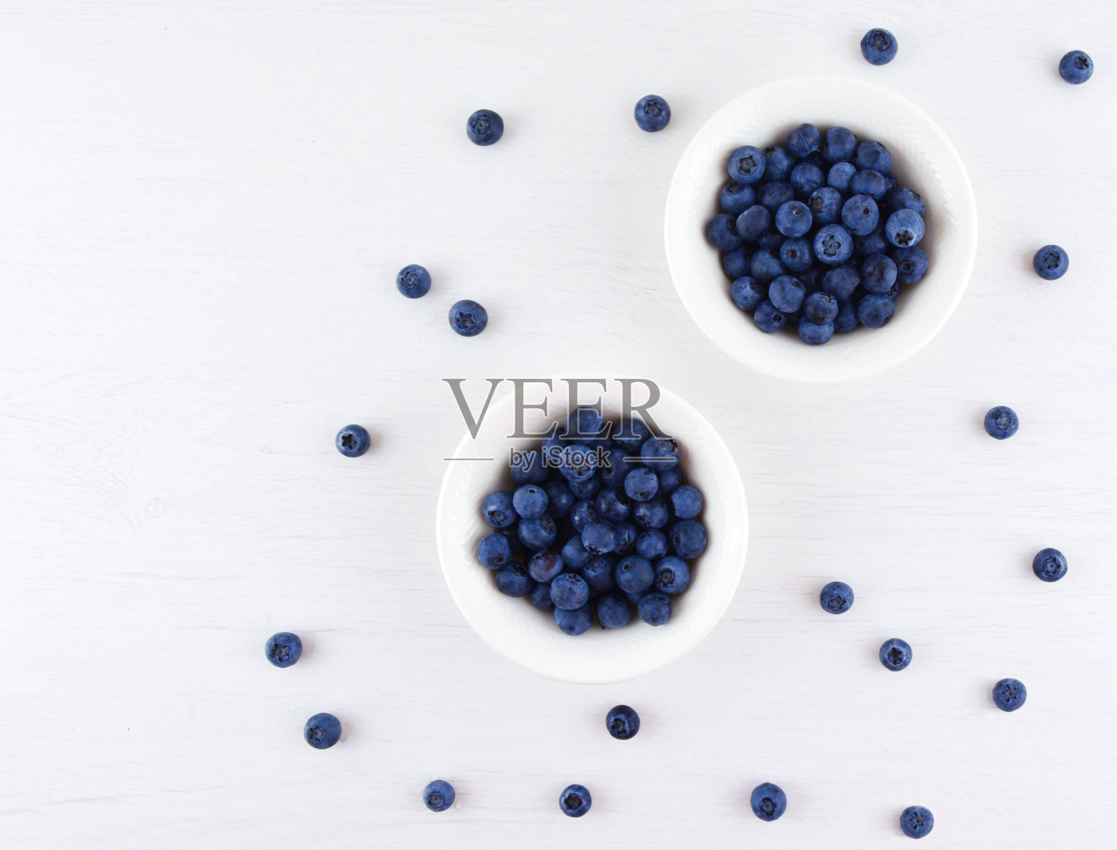 新鲜采摘的蓝莓放在白色的碗里。照片摄影图片
