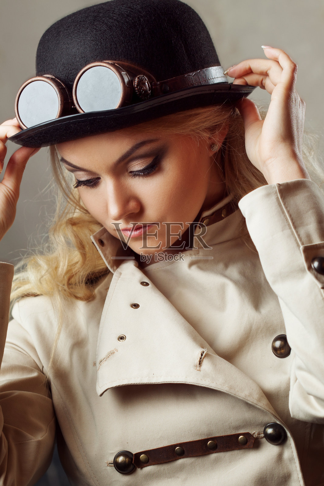 一个美丽的蒸汽朋克女人的肖像帽子圆顶礼帽在垃圾摇滚背景。照片摄影图片