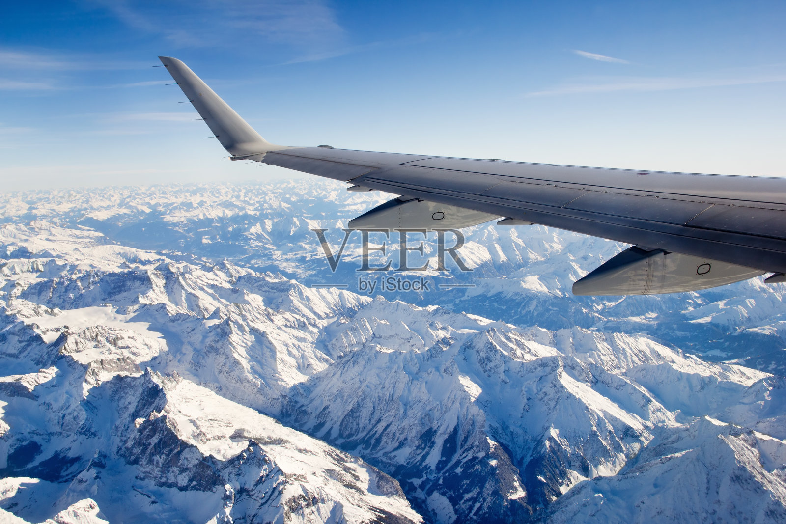 飞越白雪覆盖的阿尔卑斯山照片摄影图片