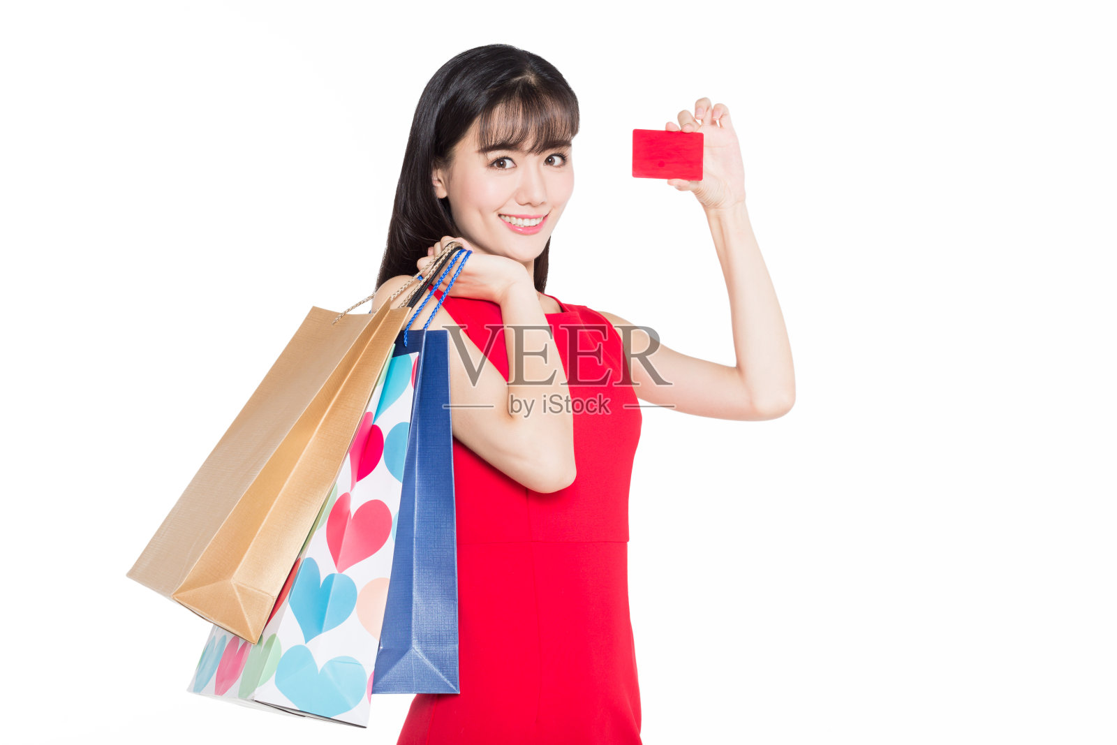 兴高采烈的女人提着购物袋，手里拿着信用卡照片摄影图片