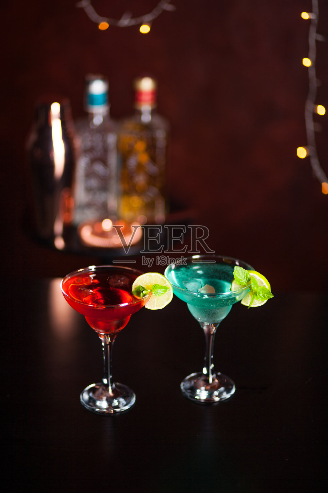 酒吧背景是粉色和蓝色的马提尼鸡尾酒。酒吧里的酒精鸡尾酒。照片摄影图片
