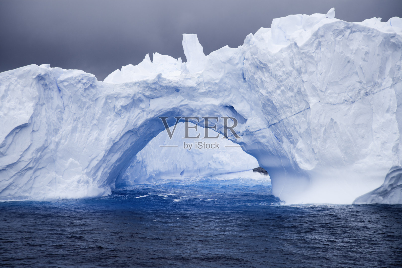 南极洲冰山上的天然拱门照片摄影图片