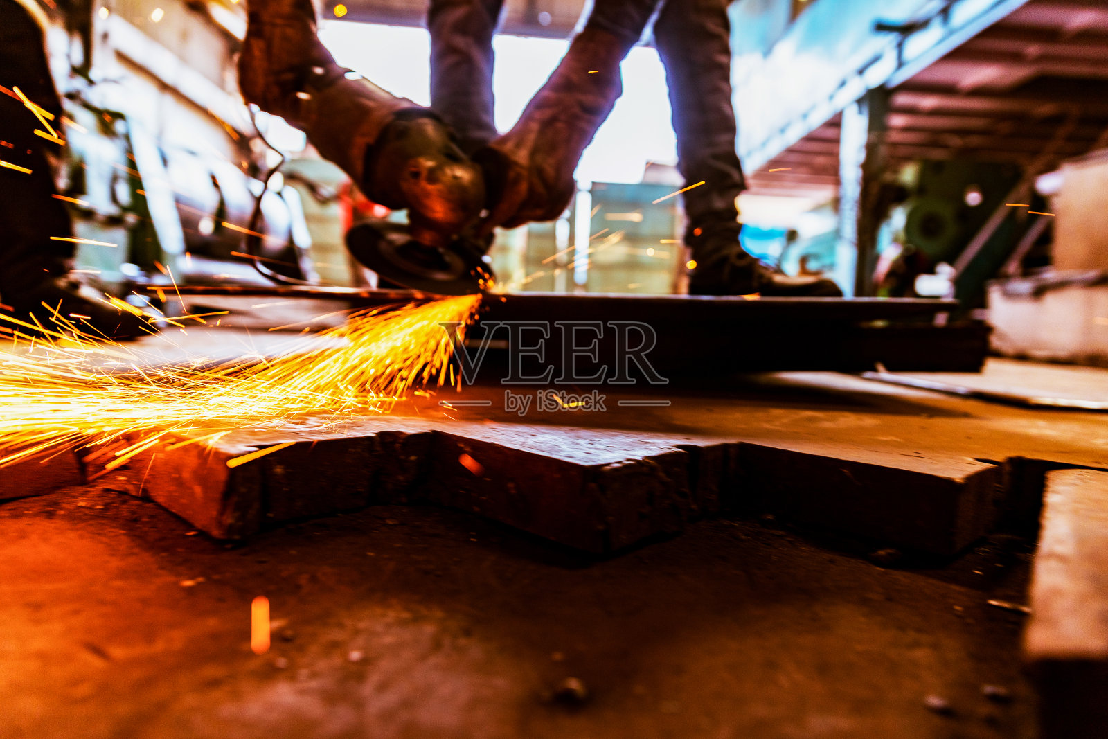 钢铁工业在努力工作，打磨地板上的金属板。照片摄影图片