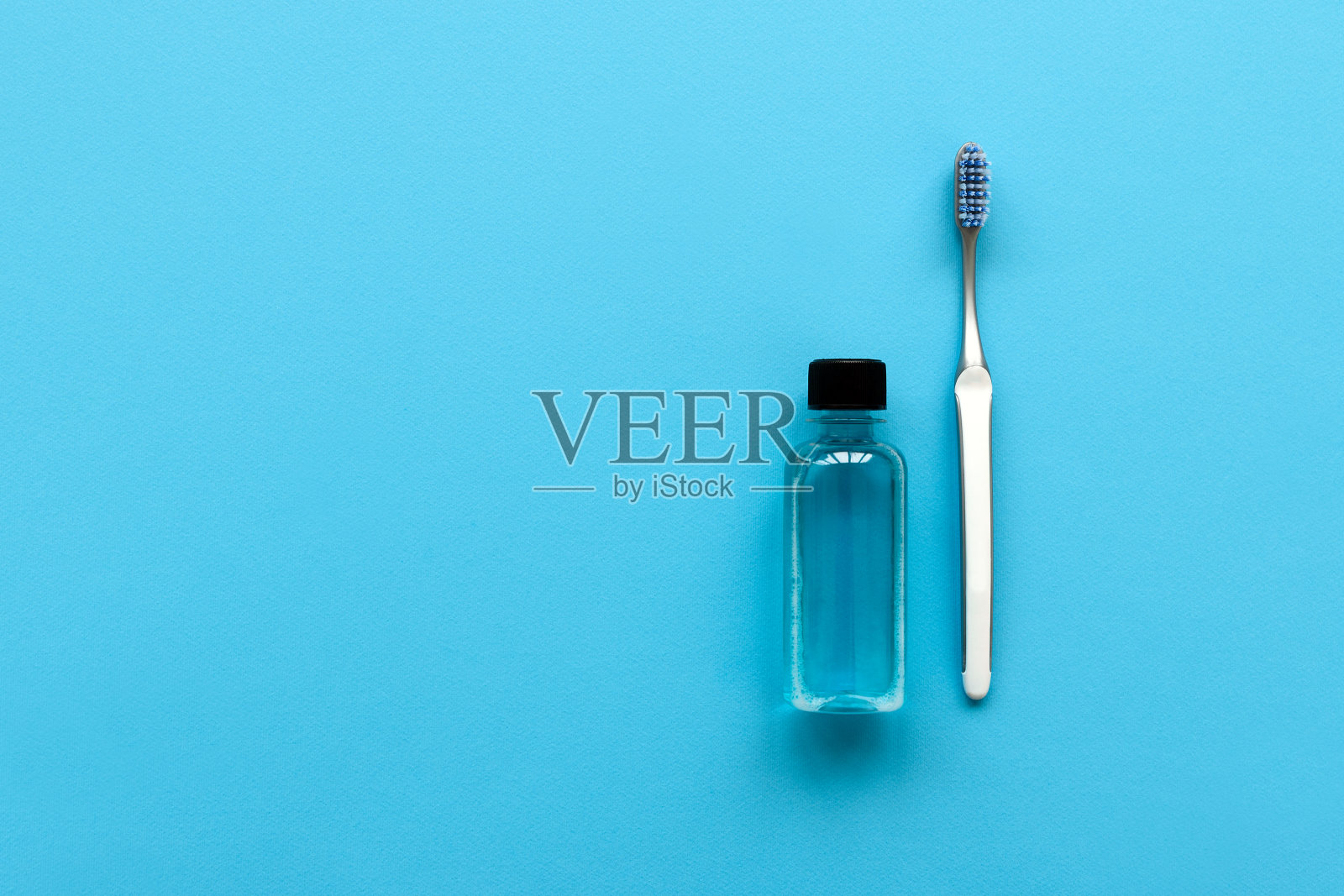 近距离的牙科牙刷和清洁剂在蓝色的背景。前视图。口腔卫生护理理念照片摄影图片