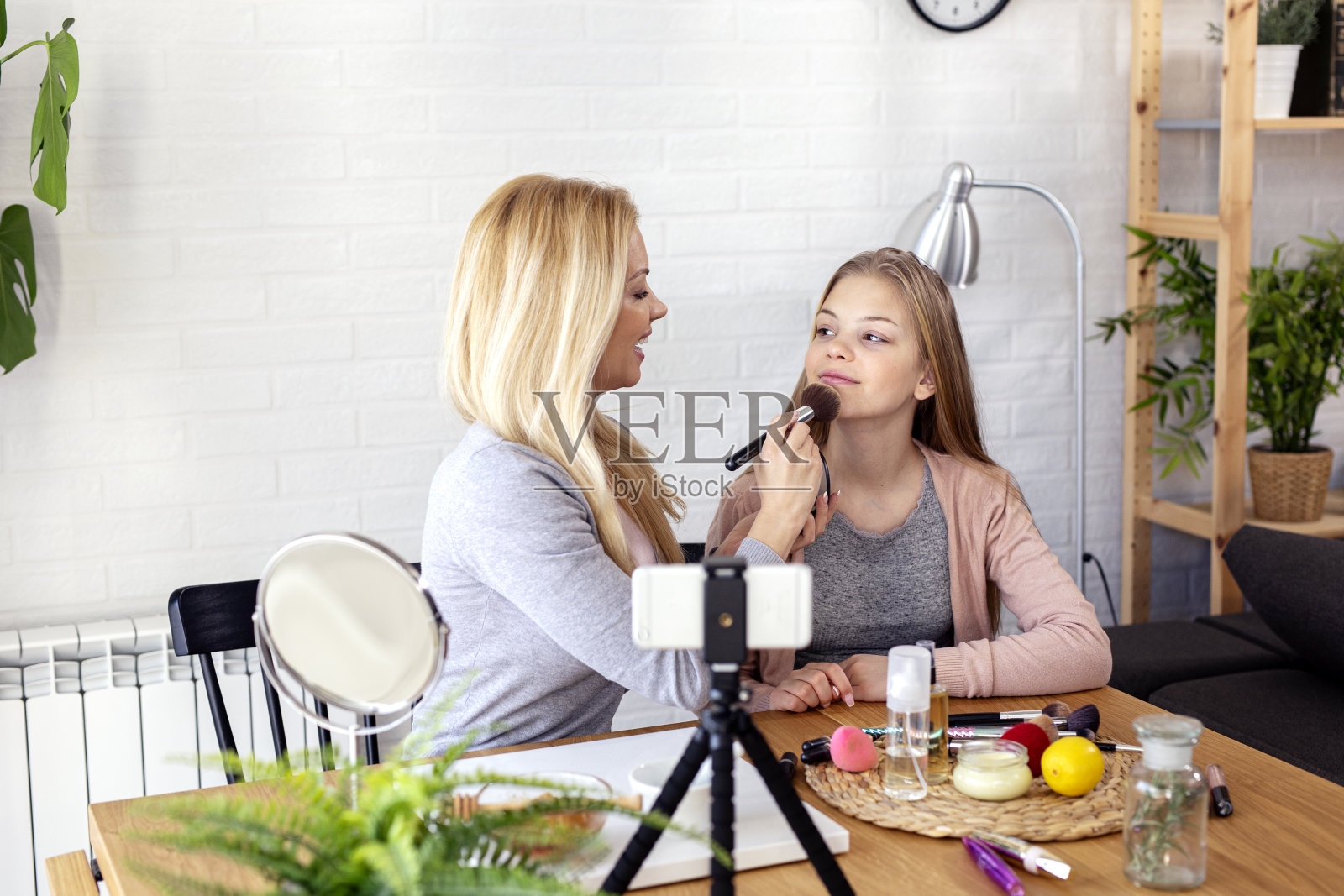 妈妈和她的女儿在家里录制视频博客与化妆主题照片摄影图片