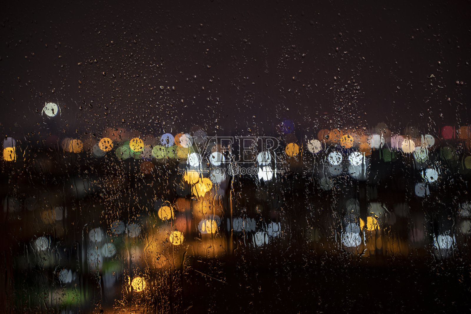 城市的背景透过窗户在雨水浸泡照片摄影图片