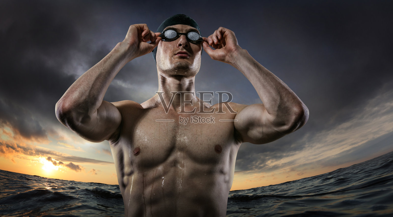 运动背景。年轻的游泳健将站在日落的河边。戏剧性的一幕。照片摄影图片