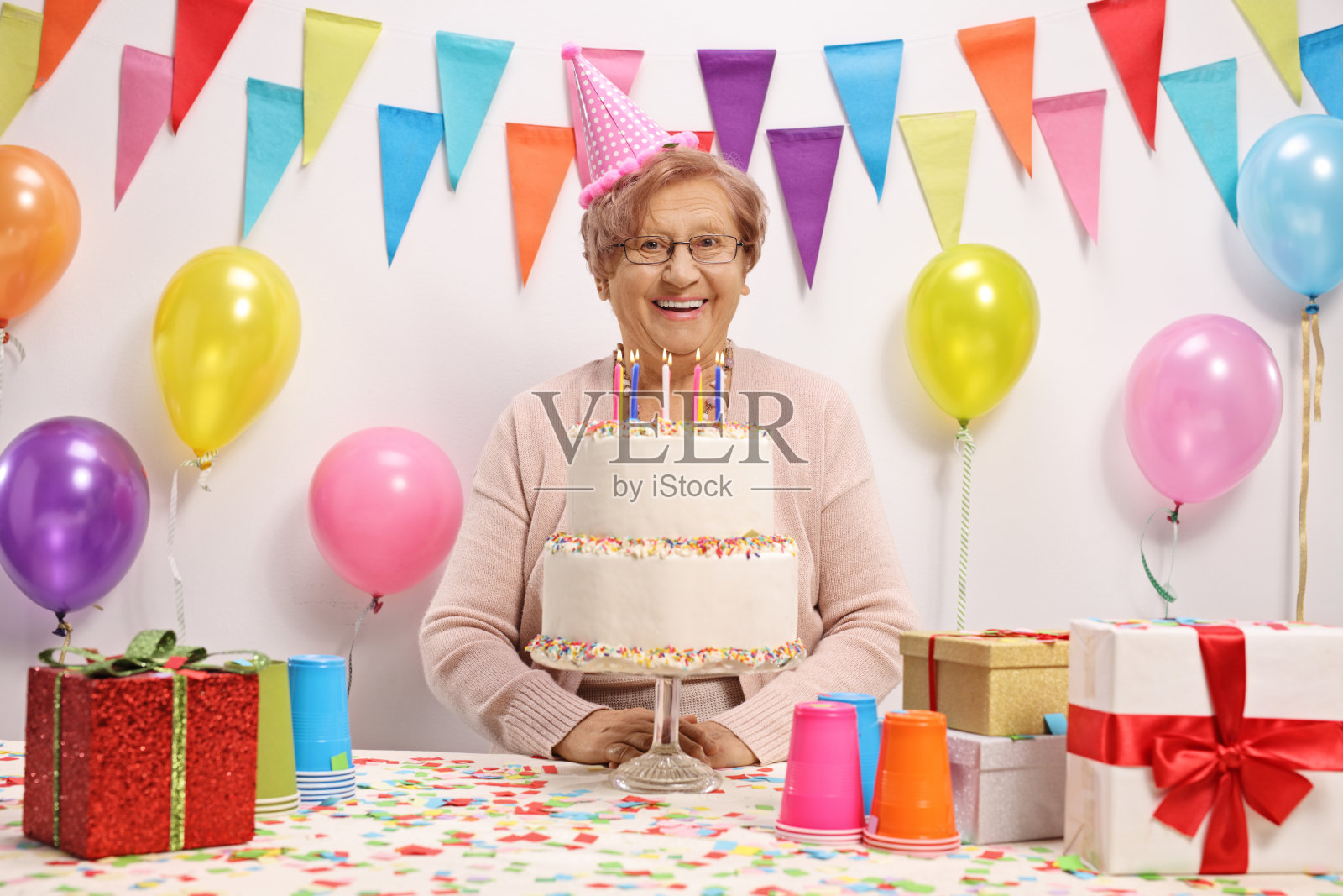 快乐的成熟女人用蛋糕庆祝生日照片摄影图片