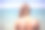年轻女子在海滩上涂着防晒霜素材图片